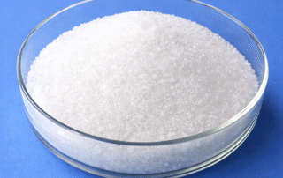 White sodium acetate crystals in a glass dish for food and industrial applications
